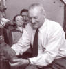 Frank Marshall holding a ventriloquist dummy head